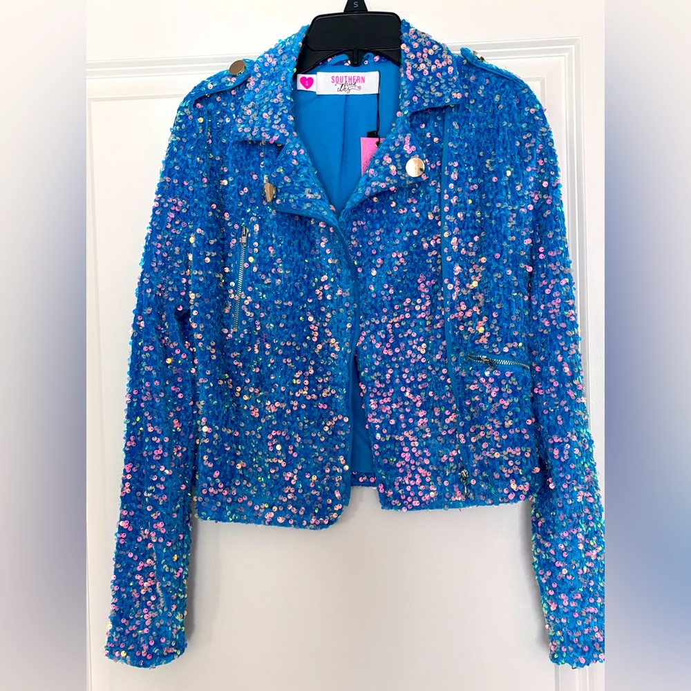 Teal sequin jacket with zip front pockets and zippers on the sleeves. Size S